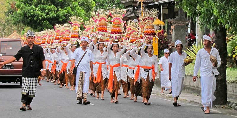 Balinese walking to a ceremony. . . welcome to Bali! Be prepared to stop and wait for 5-10 minutes, even in the middle of a main road.